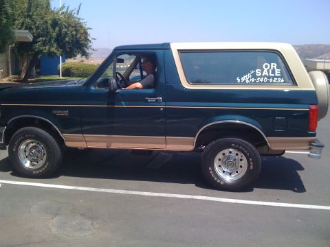1995 Ford Bronco - This Ford Bronco is for sale, with a phone number and price visible on the window.