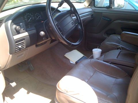 1995 Ford Bronco - Interior view of a 1995 Ford Bronco, brown leather seats and dashboard details.