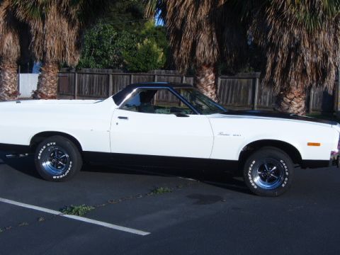 1973 Ford Ranchero - This 1973 Ford Ranchero features a two-tone paint scheme with a white body and black accents on the hood and lower panels.