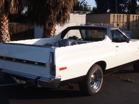 1973 Ford Ranchero - The rear of a white Ford Ranchero pickup is shown, with 'FORD' lettering on the tailgate.