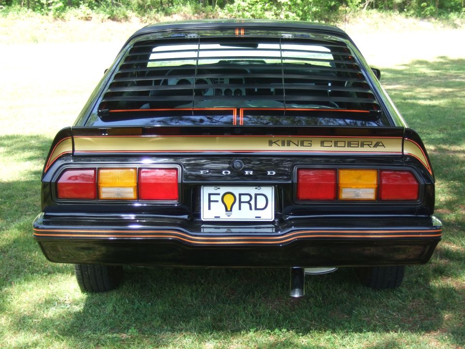 Black 1978 Ford Mustang II King Cobra rear view with gold stripes and louvers