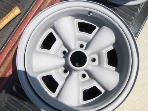 1980 Chevrolet Camaro - A close-up view of a gray five-spoke wheel, possibly undergoing restoration or preparation for painting.