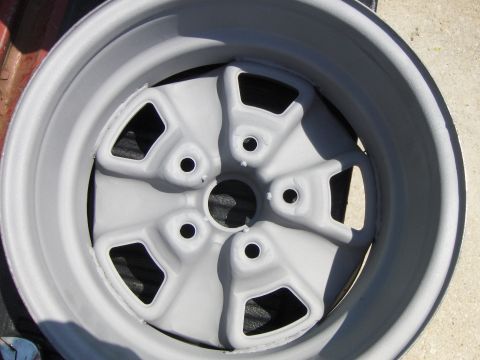 1980 Chevrolet Camaro - A gray five-spoke wheel is shown, likely a replacement part for a vehicle.