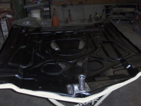 1980 Chevrolet Camaro - The underside of a car hood is shown, revealing its internal structure and bracing.