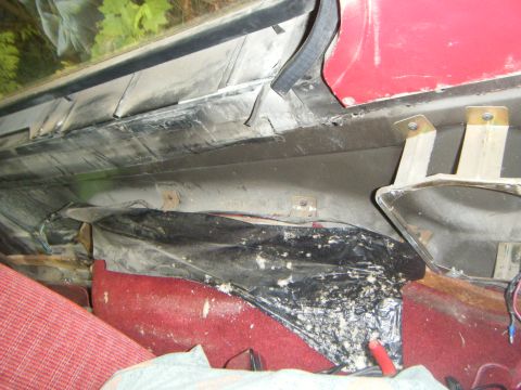 1990 Ford Bronco — Interior of red vehicle showing exposed wiring and red carpet