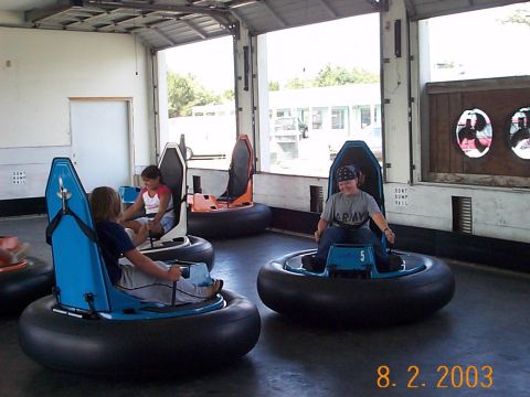1983 Ford Bronco - Bumper cars are set up for rides inside an amusement venue.