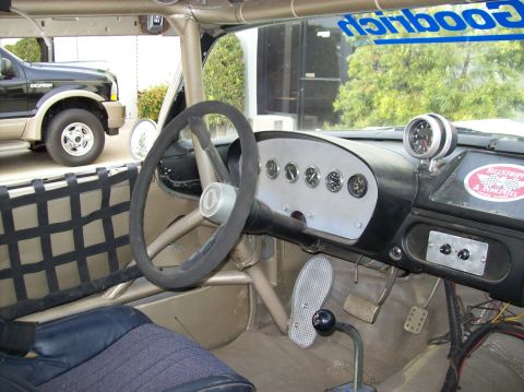1990 Ford Bronco - Custom interior with aftermarket gauges and a racing net; Ford Excursion seen outside.