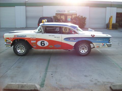 1990 Ford Bronco - This heavily modified Ford sedan is set up for off-road racing with large tires and numerous sponsor decals.