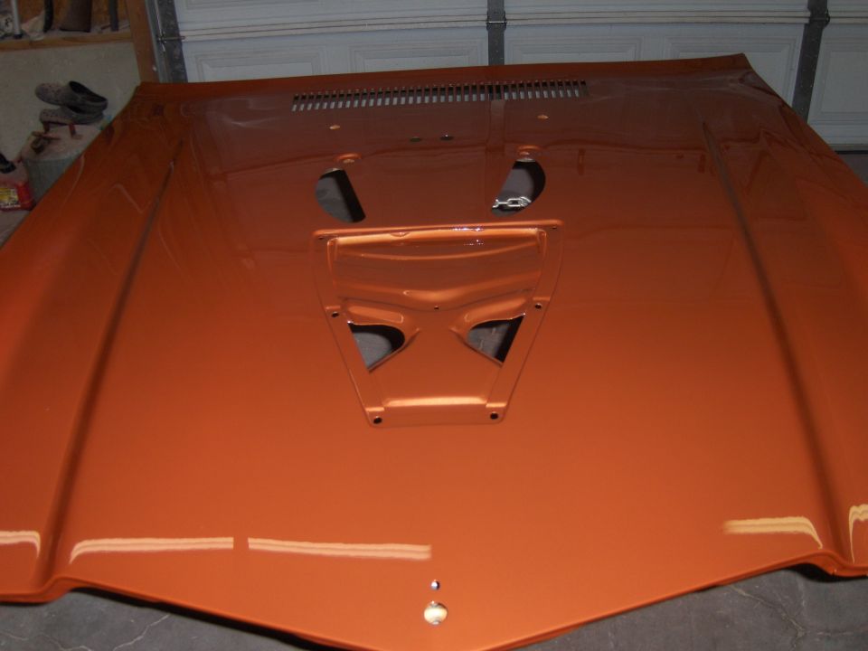 Orange hood with a prominent scoop and vents