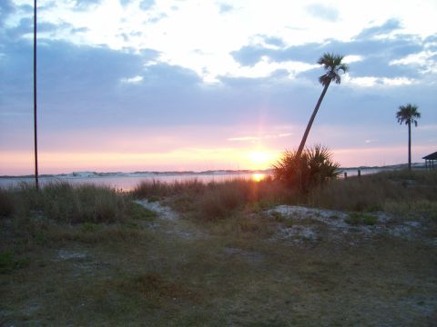 1994 Ford Bronco - Sunset over the water with palm trees and dunes in the foreground.