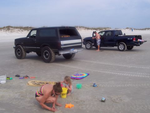 1994 Ford Bronco - A family enjoys a day at the beach with their Ford Bronco and pickup truck.