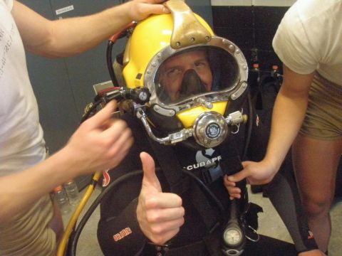 1989 Ford Bronco - Person in diving gear gives a thumbs up while being assisted with their helmet.