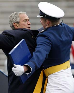 1989 Ford Bronco - George W. Bush is embraced by a military officer in uniform while holding a blue folder.