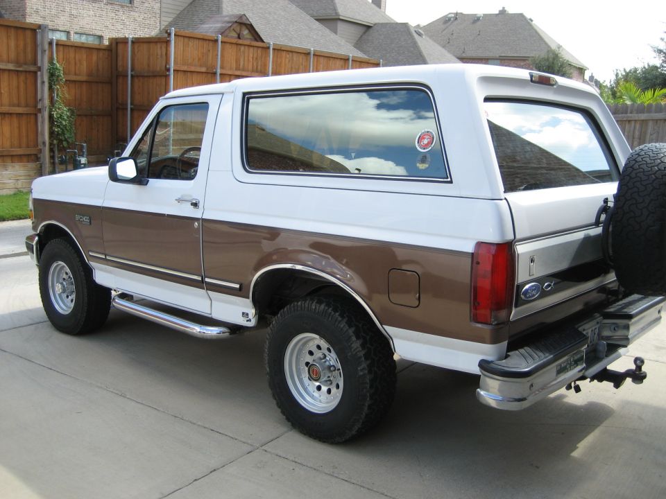 White and brown 1993 Ford Bronco rear quarter view with spare tire mounted on the back