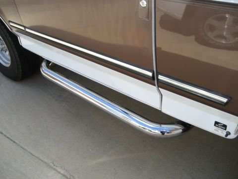 1993 Ford Bronco side view with chrome side steps and two-tone paint