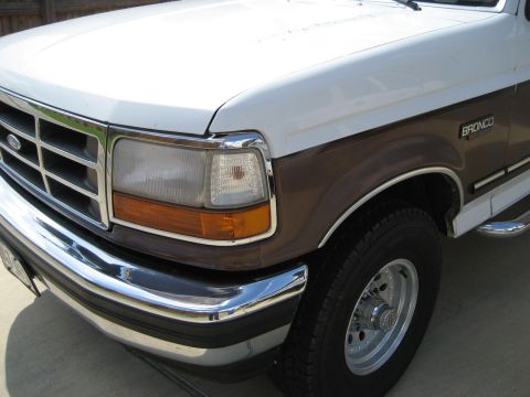 White and brown Ford Bronco front fender and headlight with chrome bumper