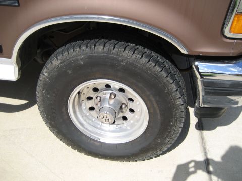 1993 Ford Bronco front wheel and fender, brown paint, chrome trim