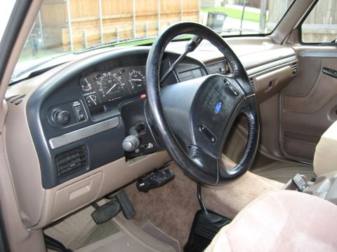 1993 Ford Bronco — 1992 Ford truck interior showing dashboard, steering wheel, pedals, and tan upholstery