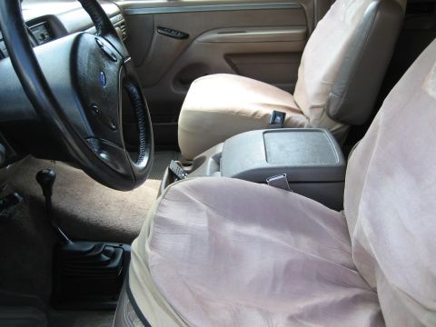 1993 Ford Bronco interior showing front seats, steering wheel, and floor shifter