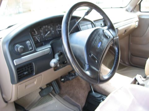 1993 Ford Bronco interior showing dashboard, steering wheel, and floor shifter