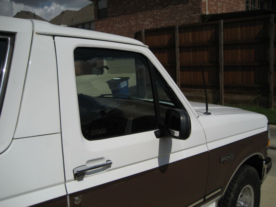 1993 Ford Bronco side view showing front door, fender, and part of the hood