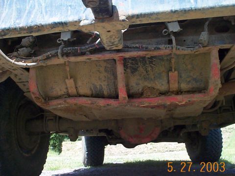 1983 Ford Bronco - Underside of a vehicle, focusing on the fuel tank and rear axle assembly.