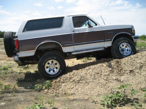1993 Ford Bronco - This lifted 1993 Ford Bronco is shown off-roading on a dirt hill.