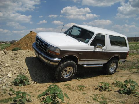 1993 Ford Bronco - This lifted 1993 Ford Bronco is shown off-road with its two-tone paint and large tires.
