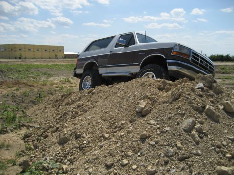 1993 Ford Bronco - 1993 Ford Bronco navigating an off-road obstacle course.