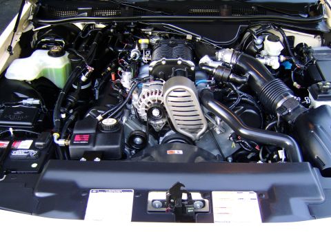 1996 Mercury Grand Marquis - Close-up view of a supercharged engine bay, highlighting key components and their arrangement.