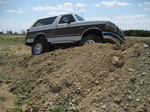 1993 Ford Bronco - This Ford Bronco is shown navigating a dirt pile off-road.