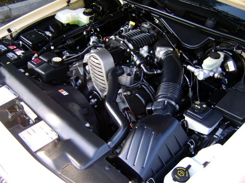 1996 Mercury Grand Marquis - Close-up view of a supercharged engine bay, showing various components and hoses.