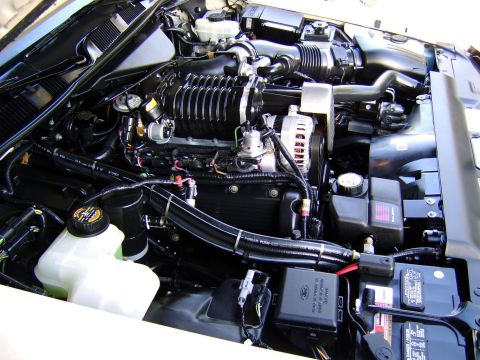 1996 Mercury Grand Marquis - Close-up view of a clean engine bay, highlighting the supercharger and various engine components.