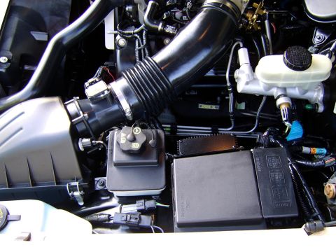 1996 Mercury Grand Marquis - Close-up view of engine bay components including air intake and fuse box.