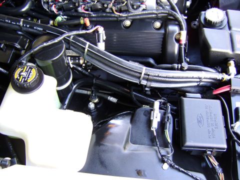 1996 Mercury Grand Marquis - Close-up view of the engine compartment of a 1996 Mercury Grand Marquis, showing various components and wiring.