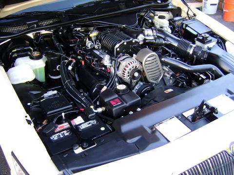 1996 Mercury Grand Marquis - Custom supercharger installed in the engine bay of a vehicle, showing various engine components.