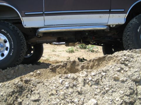 1993 Ford Bronco - The vehicle's undercarriage and tires are visible as it navigates rough terrain.
