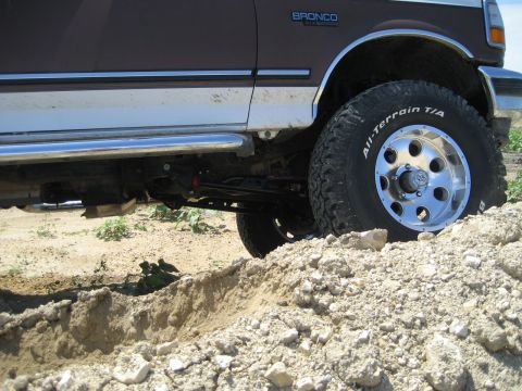 1993 Ford Bronco - 1993 Ford Bronco side view, navigating rough terrain with All-Terrain T/A tires.