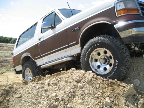 1993 Ford Bronco - This 1993 Ford Bronco is shown navigating a dirt hill with its off-road tires.