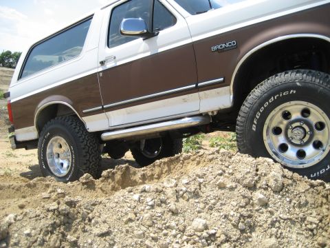 1993 Ford Bronco - This 1993 Ford Bronco is equipped with off-road tires and appears to be navigating a dirt terrain.
