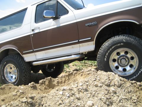 1993 Ford Bronco - This 1993 Ford Bronco is shown off-roading with its large tires on dirt.