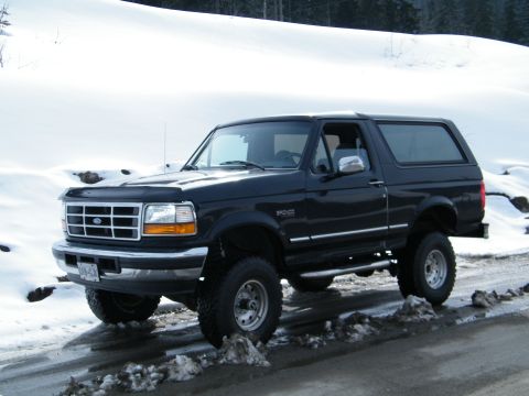 Black Ford Bronco parked on a snowy road