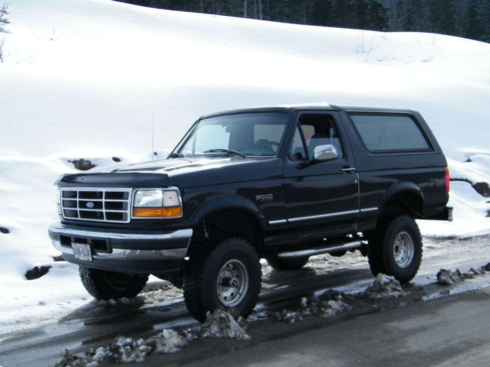 Black Ford Bronco parked on a snowy road
