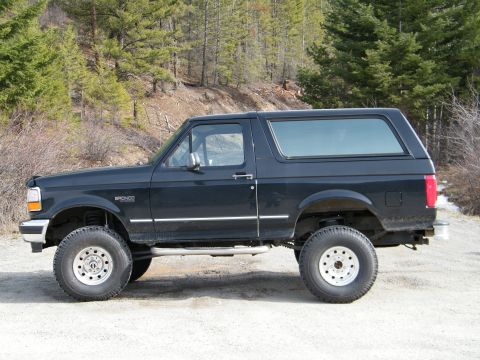 Side view of black 1996 Ford Bronco with lifted suspension and off-road tires