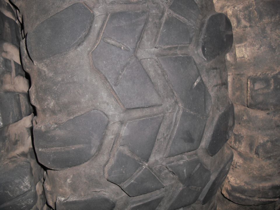 Close-up of a tire tread with a deep, aggressive pattern