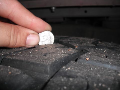 1991 Ford Bronco - A dime is used to measure the tread depth of a tire.
