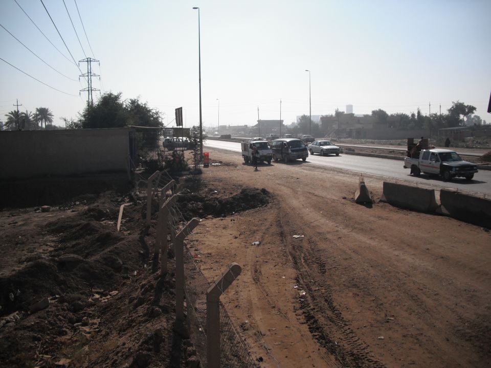 Pickup truck with people in the bed driving on a highway