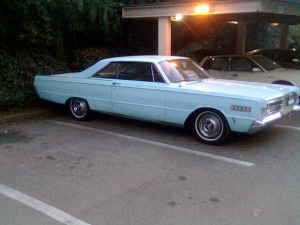 1991 Ford Bronco - A light blue coupe is parked in a lot. The vehicle has a watermark at the bottom right.