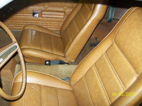 1972 Ford Mustang - Interior view of a 1972 Ford Mustang, showing the brown vinyl seats and door panels.