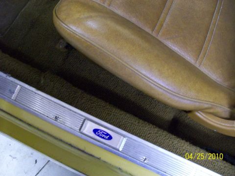 1972 Ford Mustang - Interior view of a 1972 Ford Mustang, showing the Ford door sill plate and tan seat.